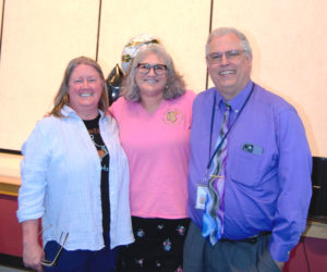 Edgecomb Eddy School Committee Chair Heather Sinclair, Edgecomb Eddy 5th grade teacher Katherine Race, and AOS 98 superintendent Robert Kahler smile after surprising Race with a party in the gym in celebration of her winning Lincoln County Teacher of the Year. (Emily Bracher photo).