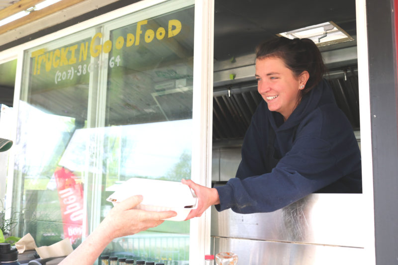 Mallory Heaberlin hands an order to a Truckin' Good Food customer. Heaberlin's truck is now in its second season at Louis Doe Home Center in Newcastle. (Christine Simmonds photo)