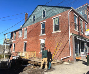 Chip Holmes and Olga Oros, owners of Damariscotta River Cruises, stand in front of 17 Friendship Road in Waldoboro, a building they purchased. Over the past few months, multiple businesses have opened within the building. (Photo courtesy Olga Oros)