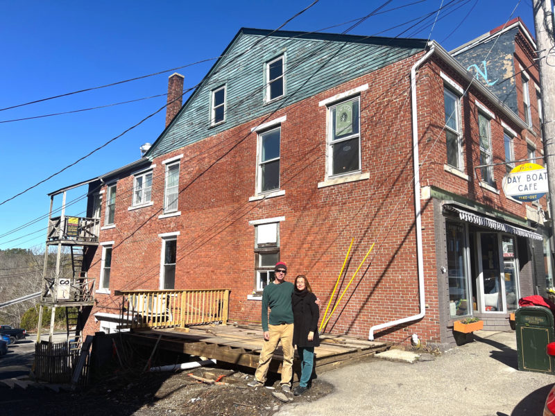 Chip Holmes and Olga Oros, owners of Damariscotta River Cruises, stand in front of 17 Friendship Road in Waldoboro, a building they purchased. Over the past few months, multiple businesses have opened within the building. (Photo courtesy Olga Oros)