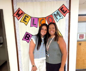 Abigail and Betsy Lash smile in one of the hallways of Miller School in Waldoboro. Abigail is wrapping up her first year teaching alongside her mother, who has been teaching there for over 20 years. (Photo courtesy Abigail Lash)