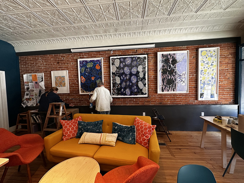 Carter Wentworth installs a displey at Perch Cafe and Bakery in preparation for the first Artwalk Waldoboro of the year. (Courtesy photo)
