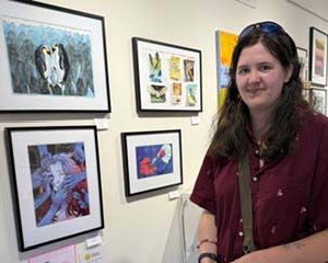 Caroline Roberts, a Scholastic Gold Key Award winner, stands near her artwork during the opening reception for the second annual Lincoln Academy student art show at Saltwater Artists Gallery on Wednesday, May 20 in New Harbor. (Photo courtesy Saltwater Artists Gallery)