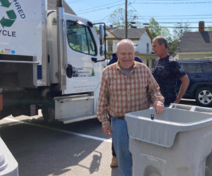 Volunteer Sarg Potter stands in front of the mobile shredding truck with a collection bin used for donated materials during a fundraiser benefiting the preservation of the Chapman-Hall House in Damariscotta. (Courtesy photo)