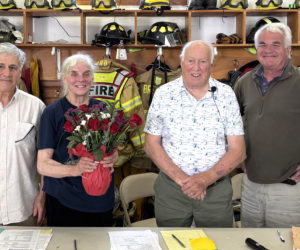 Bremen Select Board members Tom Papell and John Boe Marsh honor longtime annual town meeting moderator Don Means and outgoing board member Wendy Pieh on Saturday, June 13. The meeting was the last for Means and Pieh in their respective roles. From left: Tom Papell, Wendy Pieh, Don Means, and John Boe Marsh. (Emily Bracher photo)
