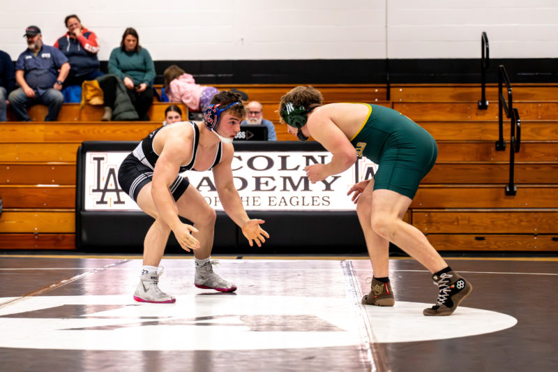 Jakobi Hagar (left) faces off against a wrestler from Oxford Hills during a Jan. 7 match at Lincoln Academy in Newcastle. Hagar, a three-time state champion, won the match. (Bisi Cameron Yee photo)