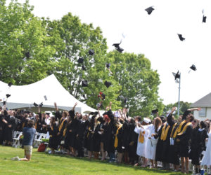 Graduates throw their caps in the air to at the close of Lincoln Academys commencement ceremony on Friday, June 5. (Emily Bracher photo)