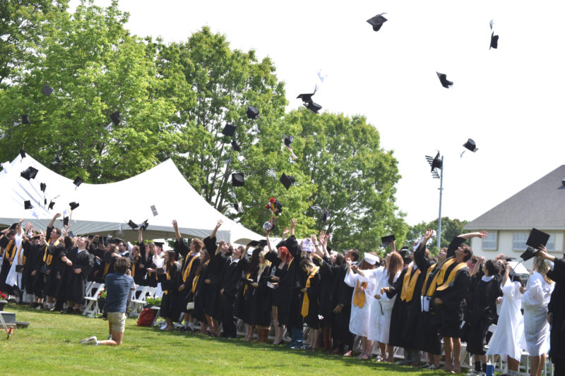 Graduates throw their caps in the air to at the close of Lincoln Academys commencement ceremony on Friday, June 5. (Emily Bracher photo)