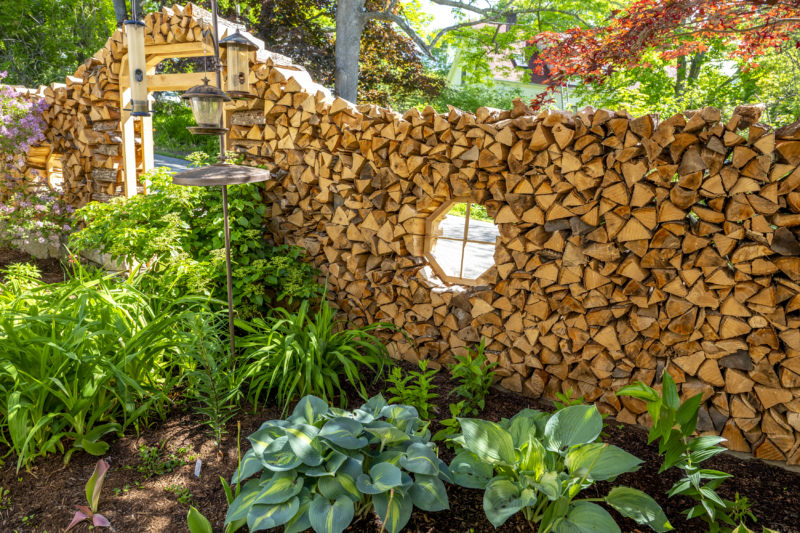 Hostas and other plants fill the small garden inside a firewood wall in Damariscotta Mills on Wednesday, June 3. The wall and garden echo the romanticised view Will Fearn and Lauren Fowler had of Maine when they moved here from Florida in 2022, they said. (Bisi Cameron Yee photo)