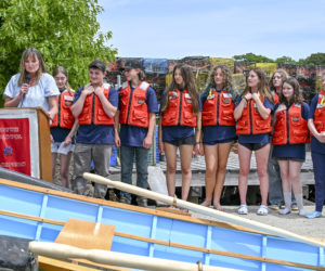 South Bristol School Principal Laurie Stiles speaks as the schools graduating class waits to enter the water during the annual boat launch in South Bristol on Wednesday, June 10. (Bisi Cameron Yee photo)
