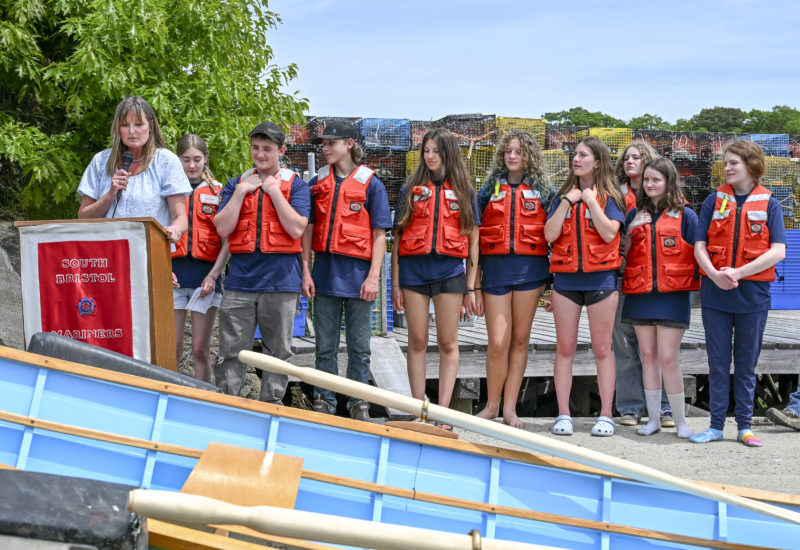 South Bristol School Principal Laurie Stiles speaks as the schools graduating class waits to enter the water during the annual boat launch in South Bristol on Wednesday, June 10. (Bisi Cameron Yee photo)