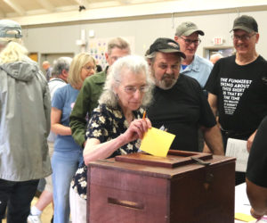 Somerville resident Shirley DErrico deposits her paper ballot in the ballot box during a special town meeting at Somerville Elementary School on Saturday, June 20. Residents considered a moratorium on mining activity, which ultimately passed 62-17. (Christine Simmonds photo)