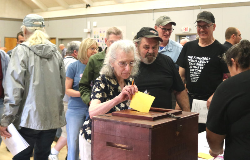 Somerville resident Shirley DErrico deposits her paper ballot in the ballot box during a special town meeting at Somerville Elementary School on Saturday, June 20. Residents considered a moratorium on mining activity, which ultimately passed 62-17. (Christine Simmonds photo)