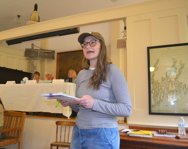 Kennebec Estuary Land Trust Executive Director Rebeccah Kolak speaks in opposition of an amendment to prohibit the nonresidential use of synthetic pesticides within the town of Westport Island during the annual town meeting on Saturday, June 20. The article ultimately did not pass. (Charlotte Boynton photo)