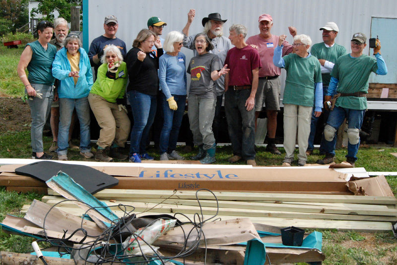 Community Cares Day volunteers strike a pose after completing some home improvement projects for a neighbor. (Photo courtesy Community Housing Improvement Project Inc.)