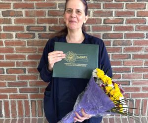 Trudy DeLong holds her DAISY Award. The award was created by the family of J. Patrick Barnes to thank nurses who make a meaningful difference in the lives of patients and families. (Photo courtesy MaineHealth)