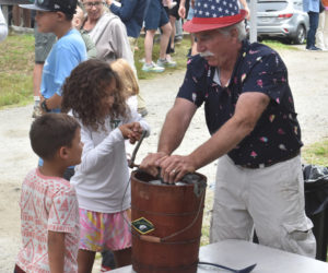 Ollie and Aubrey Quinonez use an antique, hand-crank ice cream maker with help from Kenneth Lincoln, president of the Thompson Ice House Preservation Corp. The Thompson Ice House ice cream social will be held on Sunday, July 5. (LCN file)