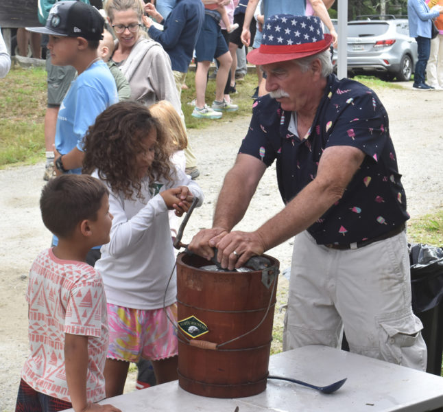 Ollie and Aubrey Quinonez use an antique, hand-crank ice cream maker with help from Kenneth Lincoln, president of the Thompson Ice House Preservation Corp. The Thompson Ice House ice cream social will be held on Sunday, July 5. (LCN file)