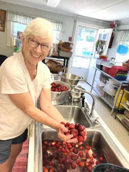 Pam Freeman, a longtime member of St. Philip's Episcopal Church and daughter of the founder of the Strawberry Festival, washes berries for shortcake. (Courtesy photo)