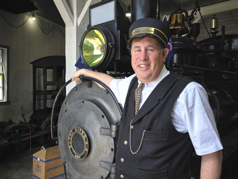 General Passenger Agent Ed Lecuyer, in his volunteer conductor uniform, rests his arm on Steam Locomotive No. 9 at the Wiscasset, Waterville and Farmington Railway Museum in Alna. No. 9 is one of two surviving locomotive from the original WW&F railroad and the only one still running. (Christine Simmonds photo)