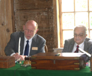 Commissioner David Levesque uses a quill to sign a document, one of the nods to Pownalborough Court House's history at the Tuesday, July 7 meeting. (Lily Wasserman photo)