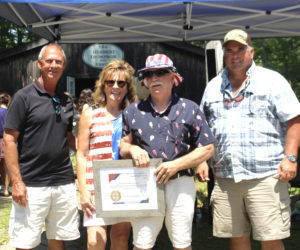 South Bristol Select Board members Robert Clifford and Adam Rice present the Spirit of America Award to Ken Lincoln and Caril-Anne Crockett Lincoln at the Thompson Ice House's ice cream social on Sunday, July 5. The Spirit of America Award is presented every year by the South Bristol Select Board in recognition of an outstanding person or organization who has served the community. From left: Robert Clifford, Caril-Anne Crockett Lincoln, Ken Lincoln, and Adam Rice. (Amelia Rice photo)