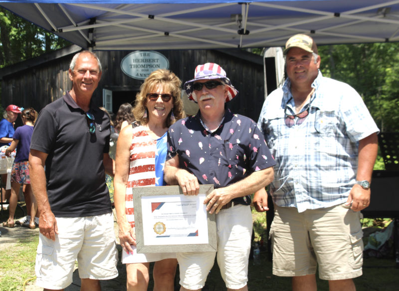 South Bristol Select Board members Robert Clifford and Adam Rice present the Spirit of America Award to Ken Lincoln and Caril-Anne Crockett Lincoln at the Thompson Ice House's ice cream social on Sunday, July 5. The Spirit of America Award is presented every year by the South Bristol Select Board in recognition of an outstanding person or organization who has served the community. From left: Robert Clifford, Caril-Anne Crockett Lincoln, Ken Lincoln, and Adam Rice. (Amelia Rice photo)