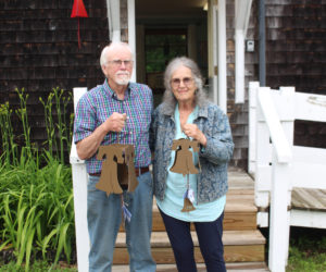 North Country Wind Bells owners Peggy and Ron Davis pose in front of the Waldoboro store with the liberty bell, which was created specifically to honor the 250th birthday of the USA. The liberty bell is available in two sizes and features a distinct tone that is deeper than the Buoy Bell. (Amelia Rice photo)
