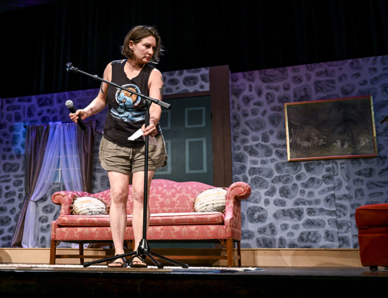 Laetitia Brundage takes advantage of an opportunity to practice using the microphone at The Waldo Theatre in Waldoboro on June 11. All of this years storytellers were experiencing reading their work from a stage to an audience for the first time. (Bisi Cameron Yee photo)