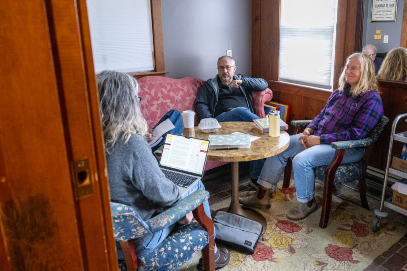 Karen Swanson (left), Jeff Mullin (center), and Jana Brownlee discuss the status of their stories during a storytelling workshop at The Waldo Theatre in Waldoboro on May 2. The 16 storytellers broke into smaller groups to share their most current drafts. (Bisi Cameron Yee photo)