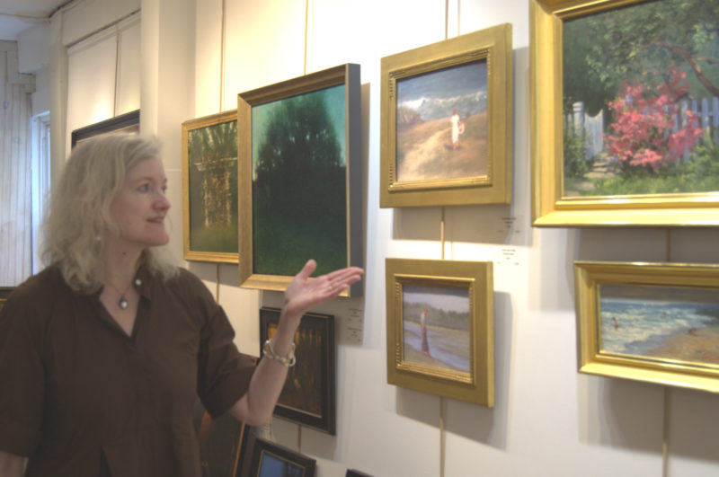 Sylvan Gallery Director Ann Scanlan points out works in her Wiscasset gallery on Tuesday, June 30. The gallery includes some of Scanlan's own works based on Wiscasset sights. (Lily Wasserman photo)
