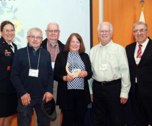 The Regulars, Community Housing Improvement Project Inc.s volunteer home repair crew, receives the award for outstanding volunteer team during the Governor's Awards for Service and Volunteerism. From left: Maj. Gen. Diane Dunn, head of the Maine National Guard; The Regulars Gerry Brookes, Wayne Gilbert, Susan Lamb, and Tim Mellen; and John Portela, president of Maine Volunteer Foundation. Not pictured: Raymond Anderson, of The Regulars. (Photo courtesy Community Housing Improvement Project Inc.)
