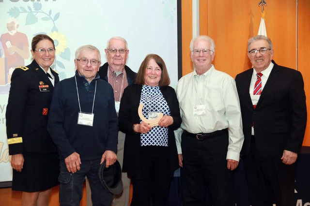 The Regulars, Community Housing Improvement Project Inc.s volunteer home repair crew, receives the award for outstanding volunteer team during the Governor's Awards for Service and Volunteerism. From left: Maj. Gen. Diane Dunn, head of the Maine National Guard; The Regulars Gerry Brookes, Wayne Gilbert, Susan Lamb, and Tim Mellen; and John Portela, president of Maine Volunteer Foundation. Not pictured: Raymond Anderson, of The Regulars. (Photo courtesy Community Housing Improvement Project Inc.)